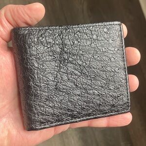black bifold wallet made from genuine ostrich leather.